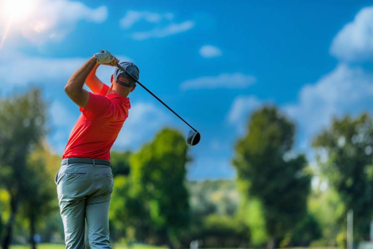 Playing golf, beautiful day, blue sky background